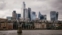 Commuters cross Millennium Bridge in view of skyscrapers on the skyline of the City of London, UK, on Tuesday, Oct. 29, 2024.