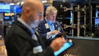 Traders work on the floor of the New York Stock Exchange during the opening bell on Nov. 13, 2024.