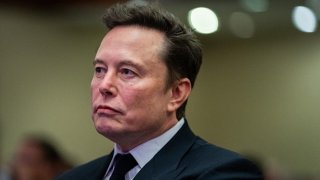 Elon Musk listens as US President-elect Donald Trump speaks during a House Republicans Conference meeting at the Hyatt Regency on Capitol Hill on November 13, 2024 in Washington, DC. 