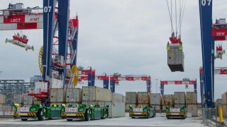 Remote-controlled cranes towering 165 feet overhead containers from vessels’ holds at the Long Beach Container Terminal in Middle Harbor at the Port of Long Beach in Long Beach, California, U.S.