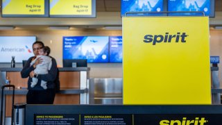 A passenger waits for assistance at the Spirit Airlines check-in counter in the Austin-Bergstrom International Airport on November 13, 2024 in Austin, Texas. 