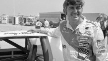 FILE - Bobby Allison stands beside his car and talks with the press after winning the pole position during qualifying for the 500 mile grand national stock car race at Pocono Raceway, Aug. 2, 1975, in Long Pond, Pa. (AP Photo/File)