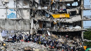 Search and Rescue teams look for possible survivors in the partially collapsed 12-story Champlain Towers South condo building on June 29, 2021 in Surfside, Florida.