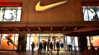 Customers shop at a Nike store in an outlet mall in Los Angeles, Nov. 8, 2024.