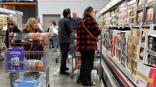 Customers shop for groceries at a Costco store on December 11, 2024 in Novato, California.