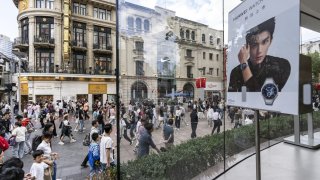 Shoppers pass a Huawei Technologies Co. store on Nanjing East Road in Shanghai, China, on Wednesday, Oct. 2, 2024.  