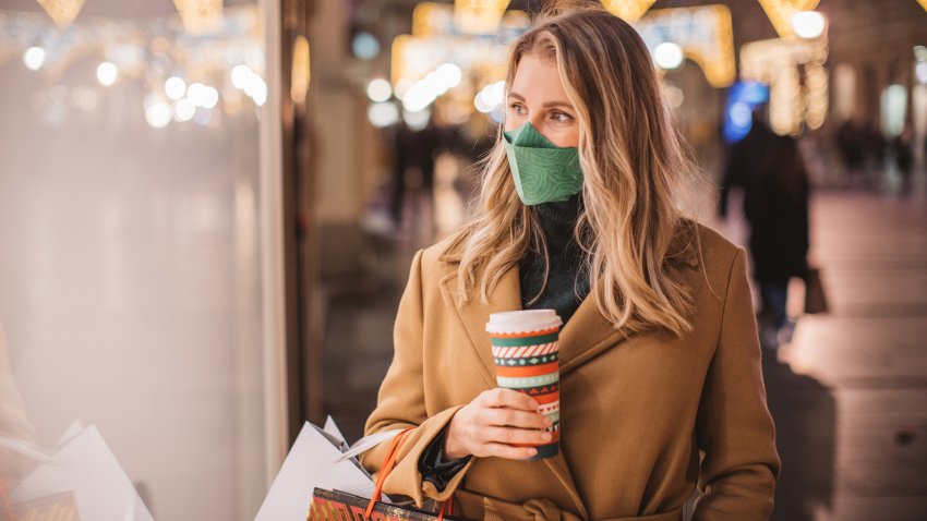 Woman wearing a face mask while Christmas shopping.