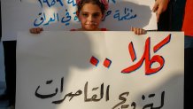 A girl holds a placard as activists demonstrate against female child marriages, in Tahrir Square in central Baghdad on July 28, 2024, amid parliamentary discussion over a proposed amendment to the Iraqi Personal Status Law. Rights advocates are alarmed by a bill introduced to Iraq's parliament that, they fear, would roll back women's rights and increase underage marriage in the deeply patriarchal society. (Photo by AHMAD AL-RUBAYE / AFP) (Photo by AHMAD AL-RUBAYE/AFP via Getty Images)