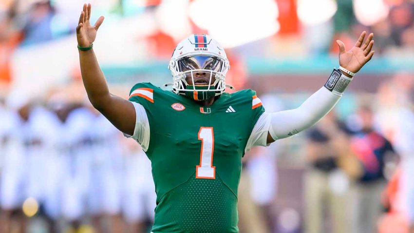 MIAMI GARDENS, FL – NOVEMBER 23: Miami Quarterback Cam Ward (1) raises his arms as he celebrates running back Jordan Lyle (not shown) scoring a touchdown  during the college football game between the Wake Forest Deacon Demons and the University of Miami Hurricanes on November 23, 2024 at the Hard Rock Stadium in Miami Gardens, FL. (Photo by Doug Murray/Icon Sportswire via Getty Images)