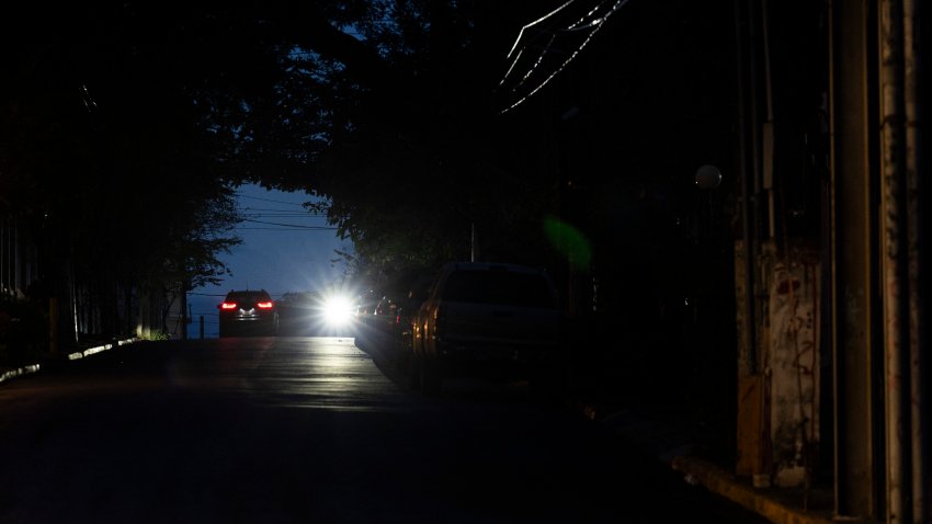 The headlights of a car lights up a dark street in San Juan, Puerto Rico after a major power outage hit the island on December 31, 2024. A major power outage plunged much of Puerto Rico into darkness Tuesday, with the US island territory’s electric utility saying restoration could take up to two days. The “island-wide blackout” began at 5:30 am (0930 GMT), Luma Energy said in a social media statement.