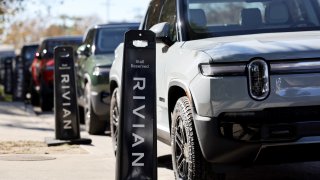 Rivian electric vehicles (EV) are parked at the Rivian Venice Hub on November 13, 2024 in Venice, California. 