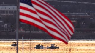 Rescuers on boats work as the sun rises at the site of the crash in the Potomac River after a Black Hawk helicopter and an American Eagle flight 5342 approaching Reagan Washington National Airport collided and crashed outside Washington, U.S., January 30, 2025.
