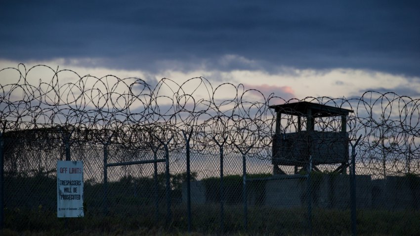 In this photo reviewed by U.S. military officials, the sun sets behind the closed Camp X-Ray detention facility, on April 17, 2019, in Guantanamo Bay Naval Base, Cuba.