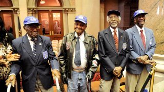 FILE – Tuskegee Airmen, from left, Audley Coulthurst of New York, William Johnson of Glen Cove, N.Y., Wilfred R. DeFour of New York, and Herbert C. Thorpe of Rome, N.Y., are honored by members of the New York Assembly upon their 75th Anniversary of the 332nd Fighter Group of the U.S. Army Air Corps during a recognition ceremony in the Assembly Chamber at the state Capitol, June 16, 2016, in Albany, N.Y.