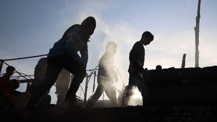 Palestinians inspect the site of an Israeli strike on a beachfront cafe amid the ongoing conflict between Israel and Hamas in Deir Al-Balah, Gaza Strip, on Jan. 14, 2025.