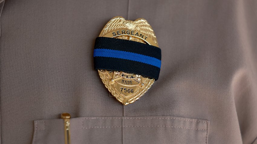 MIAMI, FLORIDA – AUGUST 19: A Miami-Dade police Sergeant wears a ribbon over his badge during the honor procession for Miami-Dade Detective Cesar Echaverry who was killed in the line of duty on August 19, 2022 in Miami, Florida. Det. Echaverry was critically wounded on August 15 by an armed robbery suspect. Echaverry was a member of Miami-Dade Police’s Robbery Intervention Detail. (Photo by Joe Raedle/Getty Images)