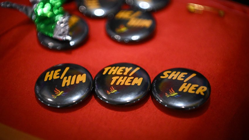 BOURNEMOUTH, ENGLAND – SEPTEMBER 25: Pronoun badges showing, ‘he, him, they, them, she and her are displayed on the LGBT+ stall in the exhibition hall, at Bournemouth International Centre, at Bournemouth International Centre on September 25, 2023 in Bournemouth, England. The Liberal Democrats are the third largest political party by number of votes in the UK. Led by Ed Davey, MP for Kingston and Surbiton, they campaign on seven core values: liberty, equality, democracy, community, human rights, internationalism, and environmentalism.  (Photo by Finnbarr Webster/Getty Images)