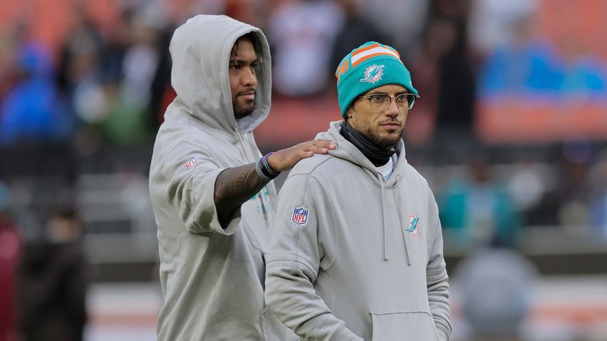 Miami Dolphins quarterback Tua Tagovailoa chats with head coach Mike McDaniel before kickoff against the Cleveland Browns on Sunday, Dec. 29, 2024, at Huntington Bank Field in Cleveland. (Al Diaz/Miami Herald/Tribune News Service via Getty Images)