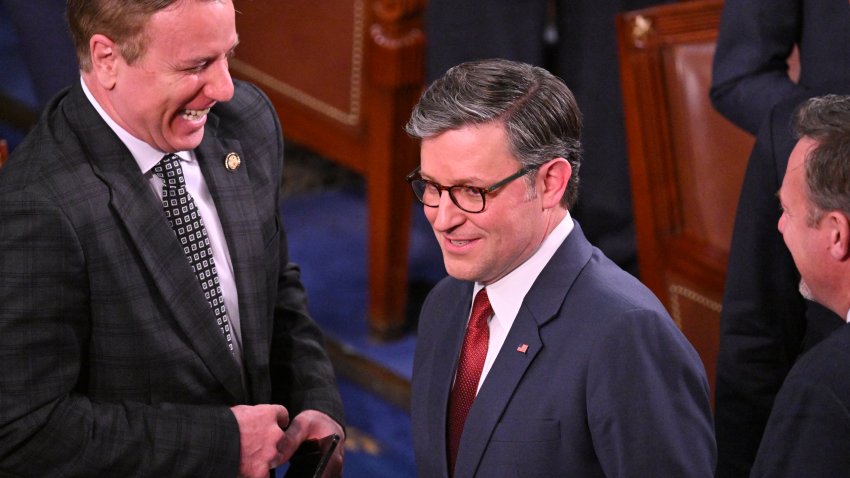 US Speaker of the House Mike Johnson (L), Republican from Louisiana, smiles during the first day of the 119th Congress in the House Chamber at the US Capitol in Washington, DC, on January 3, 2025. (Photo by ROBERTO SCHMIDT / AFP) (Photo by ROBERTO SCHMIDT/AFP via Getty Images)