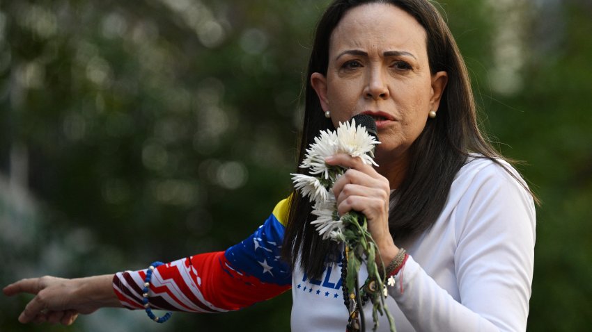 TOPSHOT – Venezuelan opposition leader Maria Corina Machado addresses supporters during a protest called by the opposition on the eve of the presidential inauguration in Caracas on January 9, 2025. Venezuela is on tenterhooks facing demonstrations called by both the opposition and government supporters. Machado, who emergend from hiding to lead protests against the swearing-in of Nicolas Maduro for a highly controversial third term as president, was arrested after being “violently intercepted upon exiting the rally,” according to her security team. (Photo by Federico PARRA / AFP) (Photo by FEDERICO PARRA/AFP via Getty Images)