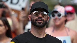 FILE - Proud Boys leader Henry "Enrique" Tarrio stands outside of the Hyatt Regency where the Conservative Political Action Conference is being held on Feb. 27, 2021 in Orlando, Florida.