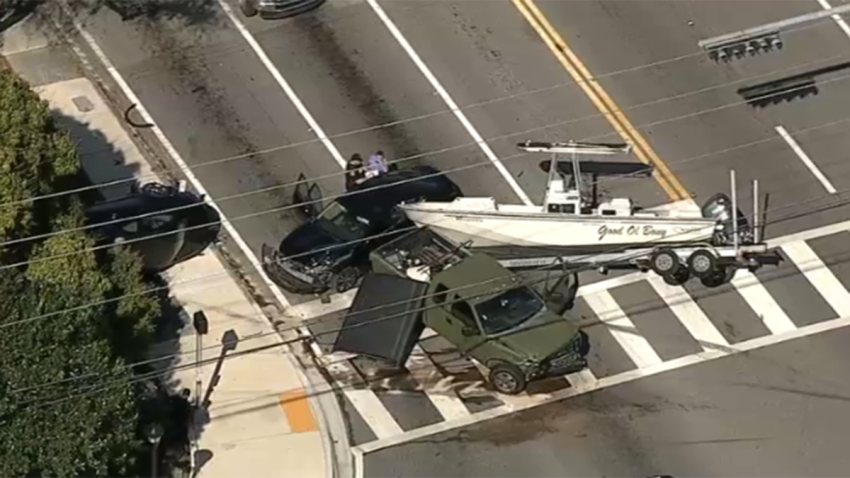A rollover crash involving multiple vehicles and a boat on a trailer caused a mess on a Miami Shores roadway Thursday.