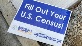 A sign encouraging participation in the U.S. Census lies on a sidewalk in Somerville, Massachusetts, U.S., August 4, 2020.