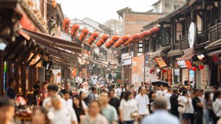 Classic Chinese courtyard featuring a stage and red lanterns hanging