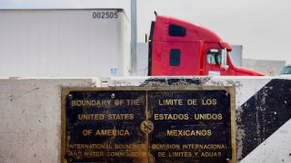 A plaque showing the boundary between the U.S. and Mexico is displayed as a truck driver waits to enter at the Calexico East Port of Entry in Calexico, California, U.S.