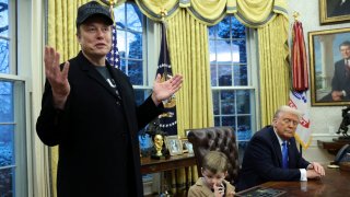 FILE PHOTO: Elon Musk speaks as his son X ? A-12 and U.S. President Donald Trump listen in the Oval Office of the White House in Washington, D.C., U.S., February 11, 2025. 