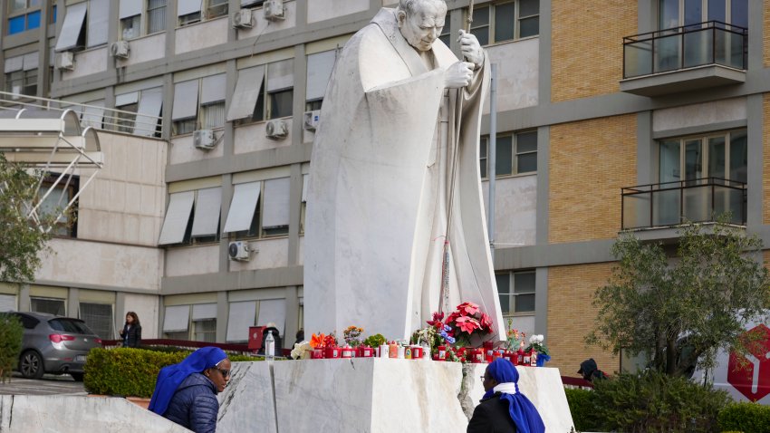 Nuns sit next to a statue of Pope John Paul II in front of the Agostino Gemelli Polyclinic, in Rome, Monday, Feb. 17, 2025, where Pope Francis has been hospitalized to undergo some necessary diagnostic tests and to continue his ongoing treatment for bronchitis.