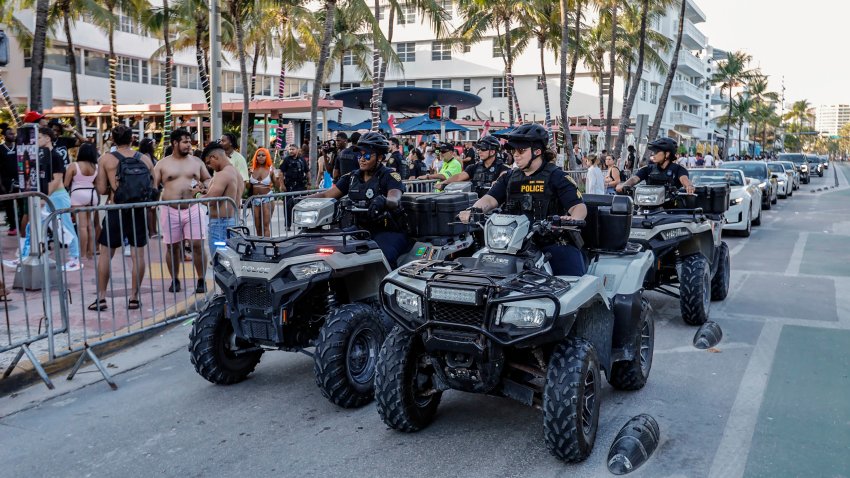 Miami Beach police officers patrol along Ocean Drive on their ATVs during spring break on Miami Beach, Florida on Sunday, March 17, 2024. (Al Diaz/Miami Herald/Tribune News Service via Getty Images)