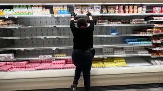File. A grocery store worker rearranges items in the depleted egg section on January 23, 2025 in Miami, Florida. Grocery stores across the nation are running short on eggs, and the situation may not improve for months. The avian influenza has killed as many as 17.2 million egg-laying hens, causing an egg shortage.