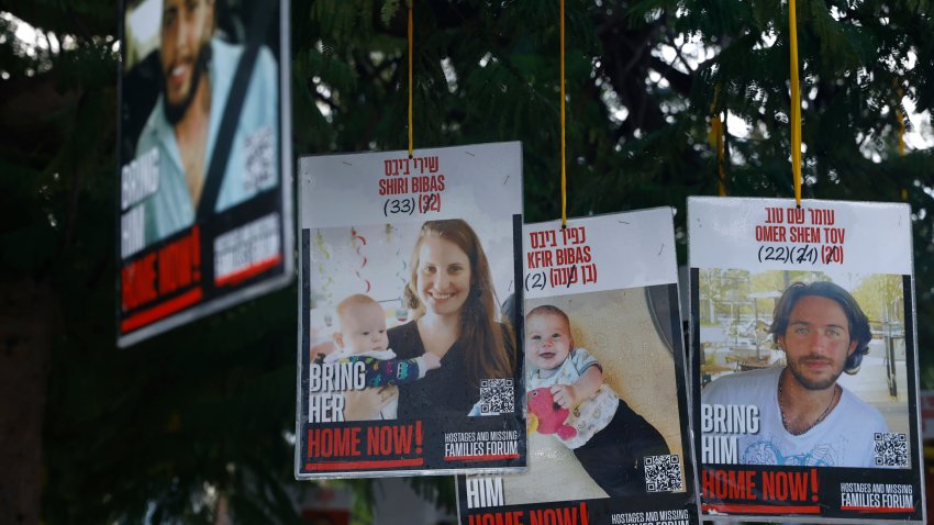 TEL AVIV, ISRAEL - FEBRUARY 20: Poster of hostages Shiri Bibas, Kfir Bibas and Omer Shem Tov are displayed in hostages square prior the handover of four bodies taken by Hamas fighters on February 20, 2025 in Tel Aviv, Israel. Four bodies of hostages including those of the Bibas family - Shiri and her young children Kfir and Ariel taken by Hamas fighters in the October 7 raids on Israel are released from Gaza. President Netanyahu has said it "..will be a very difficult day for the state of Israel. An upsetting day, a day of grief. We bring home four of our beloved hostages, deceased. We embrace the families, and the heart of an entire nation is torn. My heart is torn."