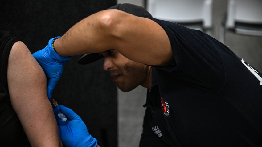 A paramedic administers a dose of the measles vaccine