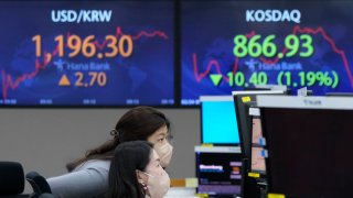 Currency traders watch monitors at the foreign exchange dealing room of the KEB Hana Bank headquarters in Seoul, South Korea, Thursday, Feb. 24, 2022.