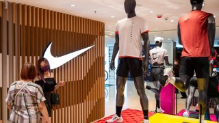 Shoppers are seen at the Nike store in Hong Kong.