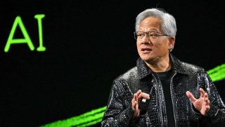 Nvidia CEO Jensen Huang holds a Blackwell GeForce RTX 50 Series GPU (L) and a RTX 5000 laptop as he delivers a keynote address at the Consumer Electronics Show (CES) in Las Vegas, Nevada on January 6, 2025.