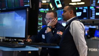 Traders work on the floor of the New York Stock Exchange on March 19, 2025.