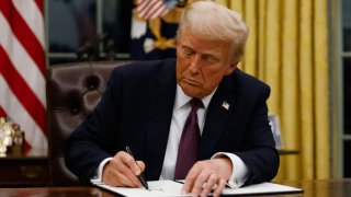 President Donald Trump signs executive orders in the Oval Office of the White House on January 20, 2025 in Washington, DC.  Trump takes office for his second term as the 47th president of the United States. 