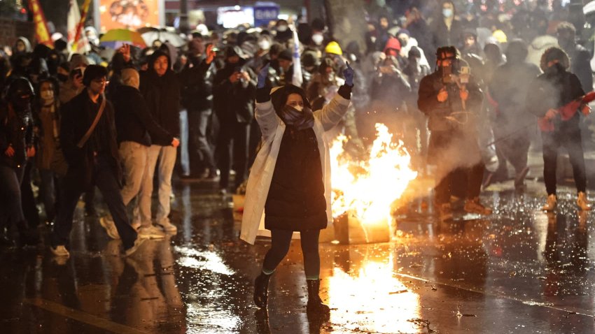 Protesters clash with Turkish anti riot police as they use tear gas and water cannons during a demonstration following the arrest of Istanbul’s mayor, in Ankara on March 21, 2025. 