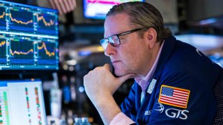 Traders work on the floor of the New York Stock Exchange on March 26, 2025.