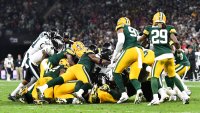Jalen Hurts is tackled by Green Bay Packers defense
