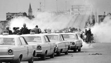 FILE - Clouds of tear gas fill the air as state troopers, ordered by Gov. George Wallace, break up a demonstration march in Selma, Ala., March 7, 1965, on what became known as "Bloody Sunday." (AP Photo, File)