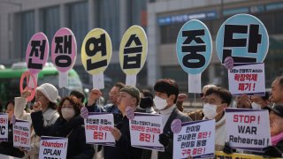 Protesters shout slogans during a press conference
