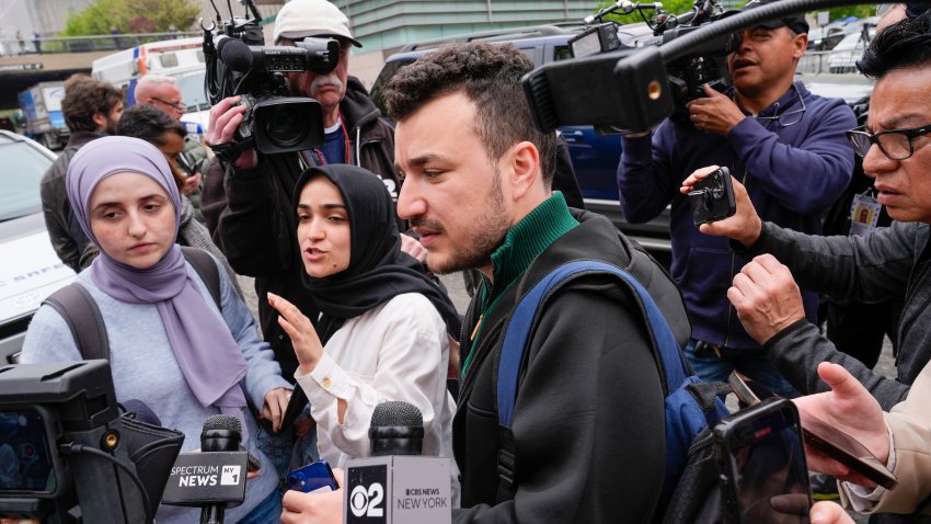 FILE – Members of the Columbia University Apartheid Divest group, including Sueda Polat, second from left, and Mahmoud Khalil, center, are surrounded by members of the media outside the Columbia University campus, Tuesday, April 30, 2024, in New York.