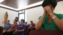 Luisa Arguello and other parishioners pray
