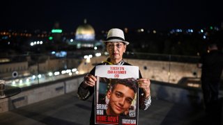 A woman holds an image of hostage Edan Alexander during the Global Day of Unity and Prayer with Israel's Hostages and Missing Families Forum, which represents the relatives of those taken captive by Palestinian Hamas militants during the October 7 attack, in Jerusalem on October 25, 2023.