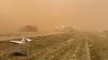 At least six dead as threat of tornadoes moves south and blinding winds fan wildfires