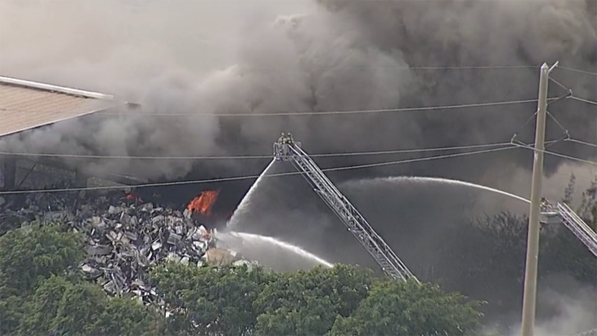 Crews battle large fire at scrap metal yard in NW Miami-Dade